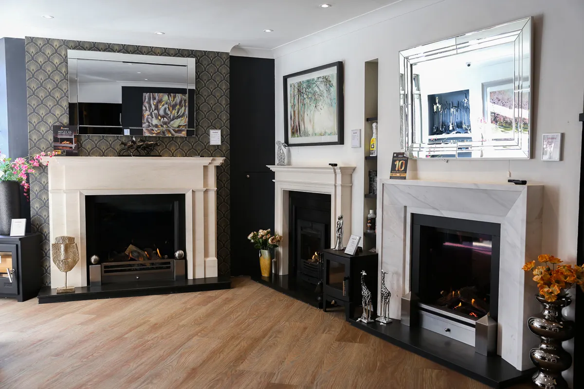 A showroom interior with fireplace displays and mirrors